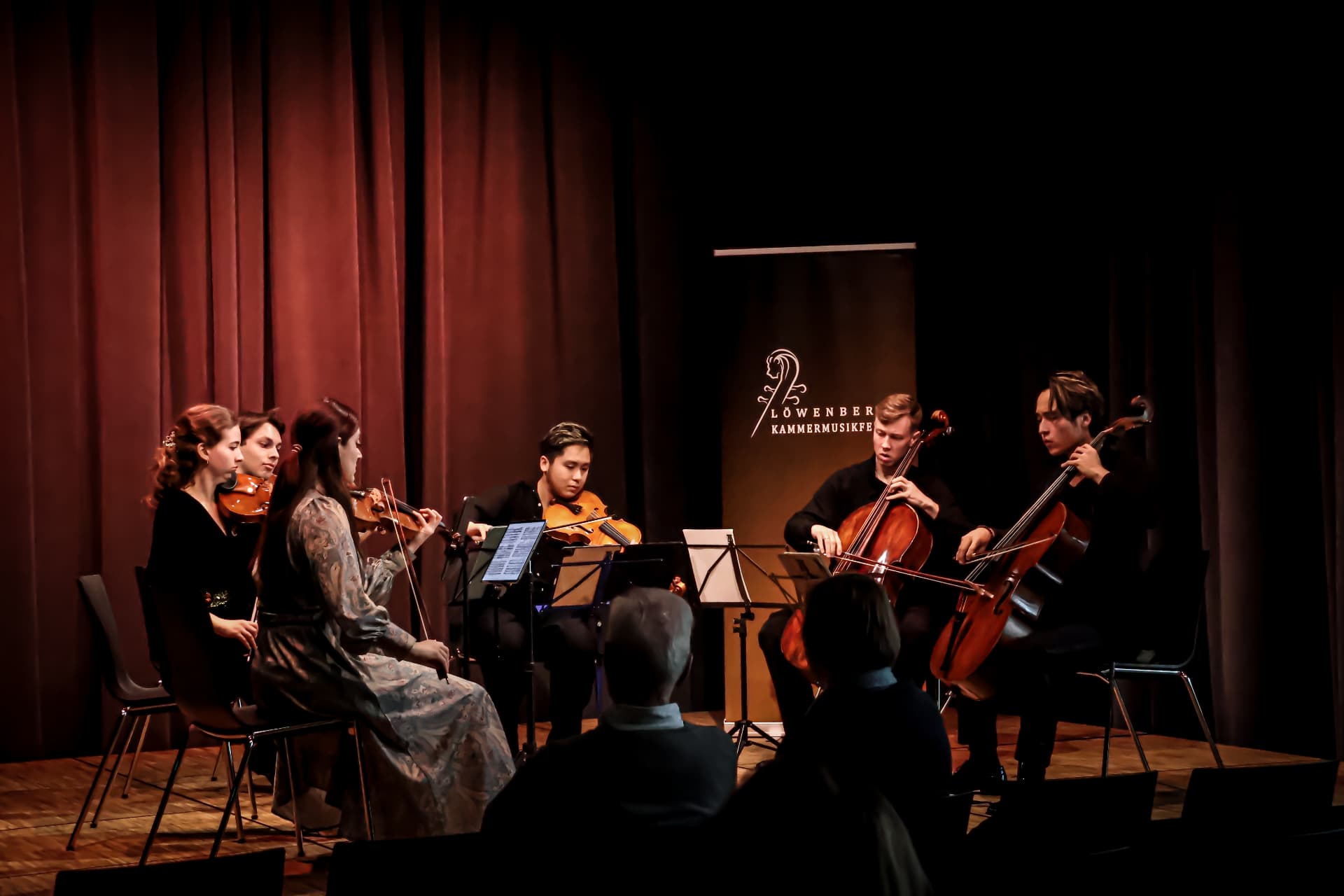 String quintet performing together on stage