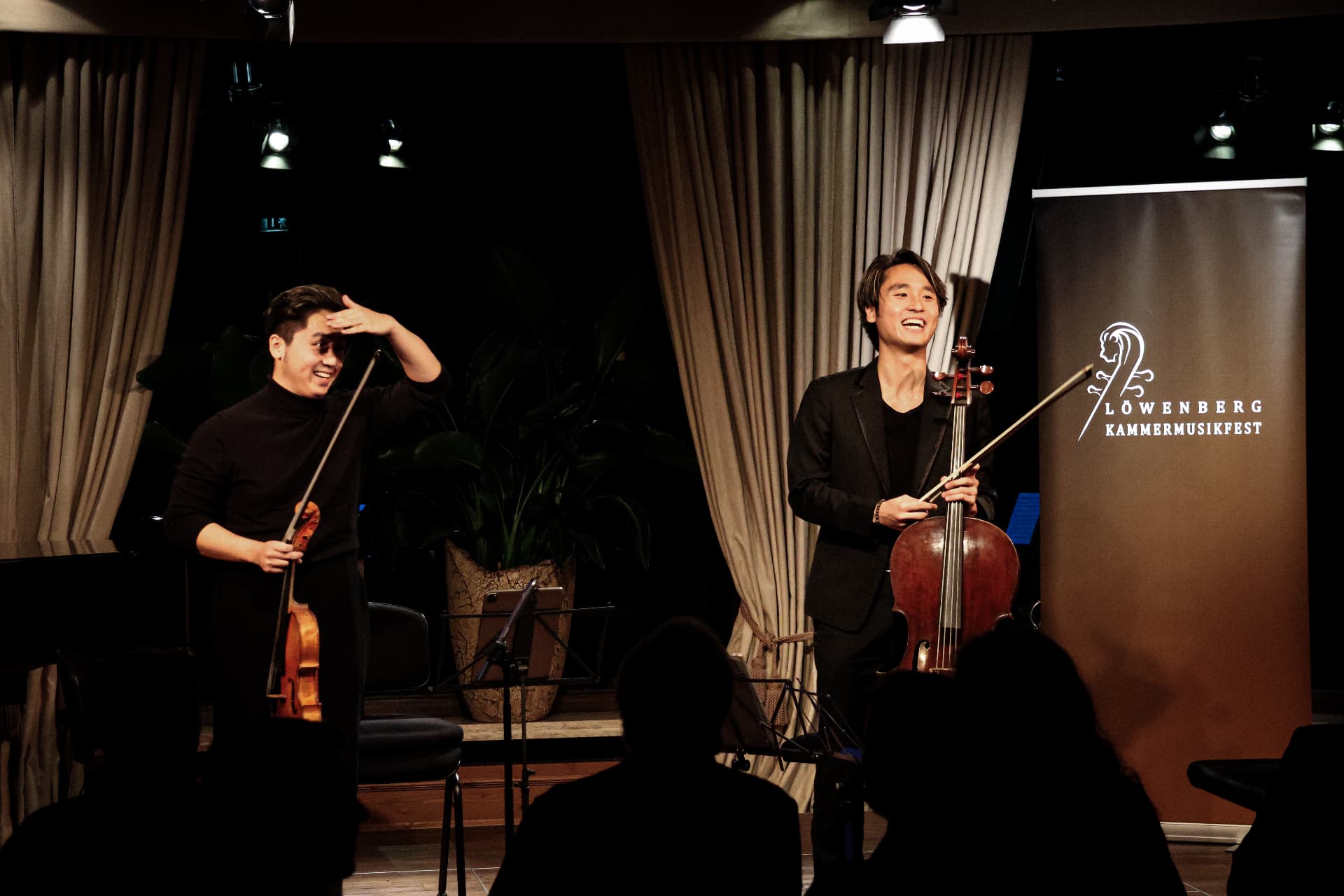 Two musicians greeting the audience on stage